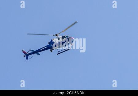 Suffolk County Police Department helicopter flying over Montauk Point, Montauk, NY Stock Photo