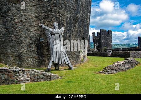 Model figure 'holding-up' the leaning tower of Caerphilly castle. Wales. UK Stock Photo