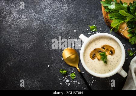 Mushroom Soup in craft bowl on dark stone table. Stock Photo