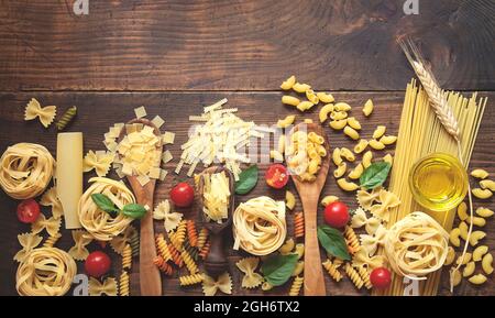 Various pasta on wooden background Stock Photo
