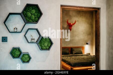 Haxagon shelves with decorative elements on grey color wall. Interior design. Stock Photo