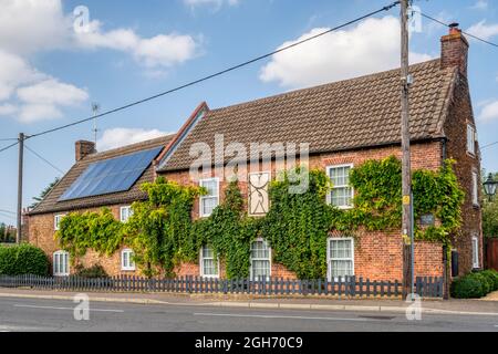 Cottages in Chapel Road, Dersingham in West Norfolk.  One property with solar panels on roof. Stock Photo