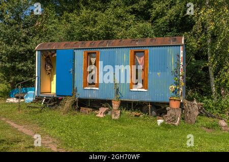 Old construction trailer converted into a caravan Stock Photo