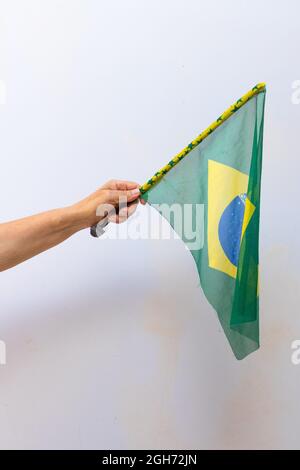 Holding Brazil flag isolated on white background. Stock Photo