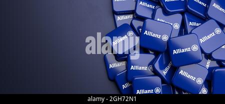 Logos of the German insurance and financial services group Allianz on a heap on a table. Copy space. Web banner format. Stock Photo