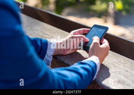 Unrecognizable caucasian business woman using mobile phone. Stock Photo