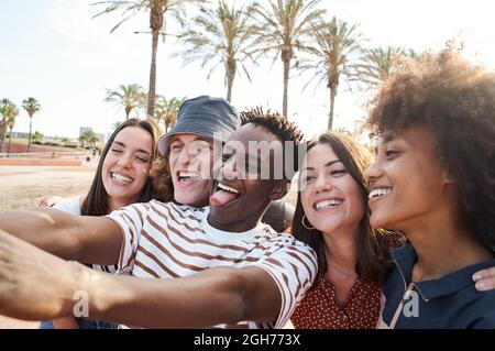 Young interracial friends take a picture. Group of people enjoying their free time together. Stock Photo