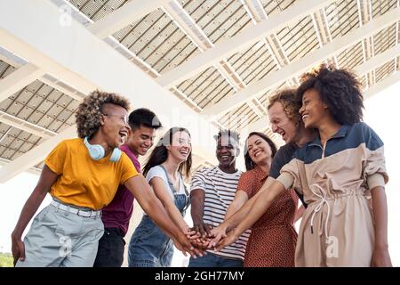 Group of friends stacking hand and happy to be together. Multiethnic people. Stock Photo