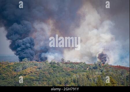 Close up of flames and billowing clouds of grey smoke at the Foresthill Bridge fire in Northern California near Auburn in the Sierra Nevada foothills. Stock Photo