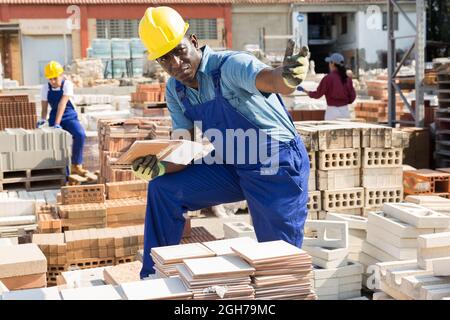Builder is choosing ceramic tiles in building store Stock Photo