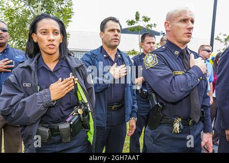 Miami Florida,Overtown Black Police Precinct & Courthouse Museum grand opening,Hispanic men women officers,Pledge of Allegiance police uniform Stock Photo