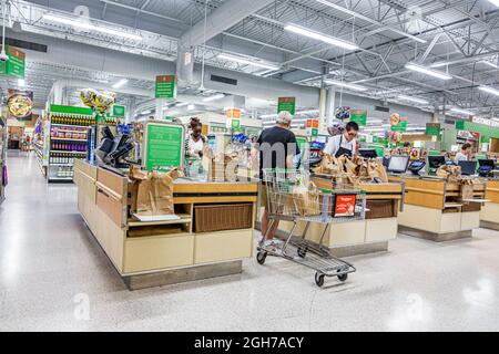 Stuart Florida,Publix grocery store supermarket food,interior inside checkout woman female cashier worker Black man customer Stock Photo