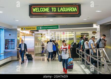 New York City,NY NYC Queens,LaGuardia Airport LGA terminal,travelers airline passengers men male female women interior inside Stock Photo