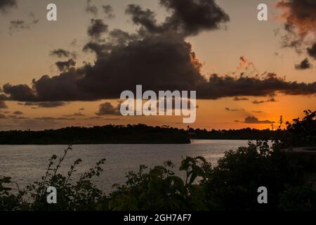 Camacari, Bahia, Brazil - October 17, 2015: Beautiful orange and yellow sunset with dramatic clouds in Camacari, Bahia, Stock Photo