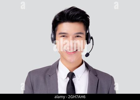 Portrait young asian business man call center wearing headset isolated on white background, agent with support and service, businessman is assistant f Stock Photo