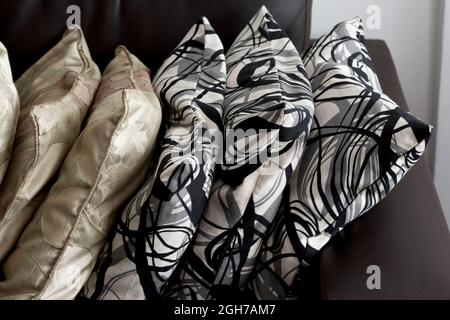 Different pillows arranged on a sofa inside a residential apartment. Salvador, Bahia, Brazil. Stock Photo