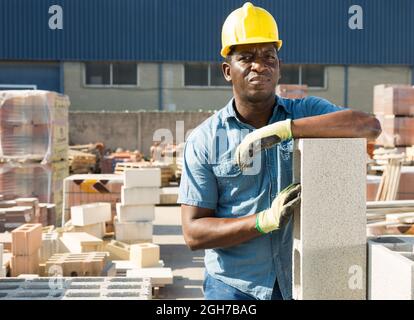 Portrait of a concentrated african american man worker standing in a warehouse Stock Photo