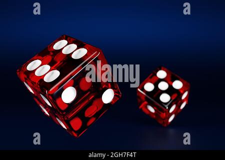 3D illustration closeup of a pair of red dices over dark background. Red dice in flight. Casino gambling. Stock Photo