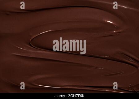 Melted chocolate swirl, macro image. Chocolate texture background. Liquid chocolate close-up. Baking ingredient. Stock Photo