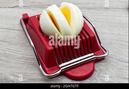 Hard boiled egg slicer tool. Household device for slicing egg. Stock Photo