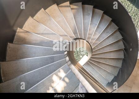 Bangkok, Thailand - May 15, 2020 : Upside view of a spiral staircase pattern. Spiral stairs circle in courtyard architecture. Outdoor ladder decoratio Stock Photo