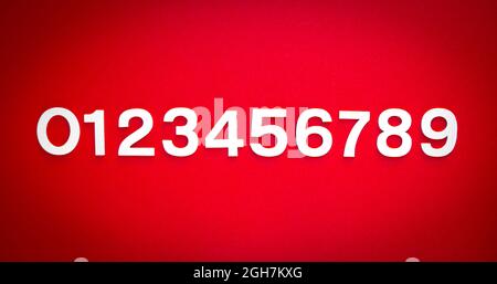 Mathematics background made with solid numbers from 1 to 9 on a red blackboard Stock Photo