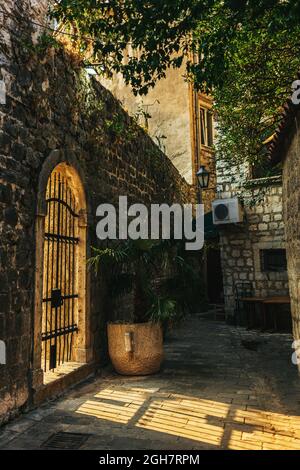 Beautiful old street in Kotor, Montenegro. Old buildings of Kotor. Amazing sunlight. Stock Photo