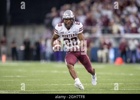 Montana Grizzlies running back Isiah Childs (28) runs with the ball during the fourth quarter of an NCAA college football game against the Washington Stock Photo