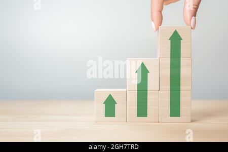 Hand arranging wood cube stacking as step stair Stock Photo - Alamy