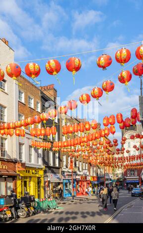 Colourful red and gold Chinese lanterns strung across Little Newport Street in Chinatown in the West End of London, City of Westminster W2 district Stock Photo