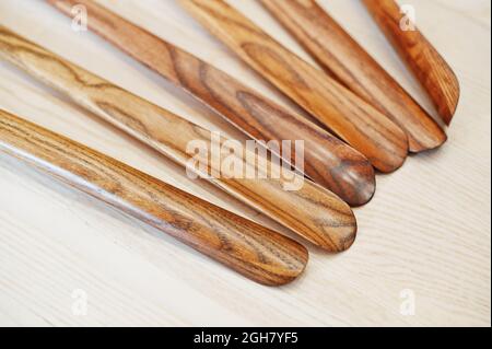 Hand carved oak wooden shoe horn. Shoes accessories. Home styling spoon. Stock Photo