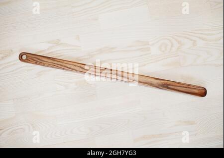 Hand carved oak wooden shoe horn. Shoes accessories. Home styling spoon. Stock Photo