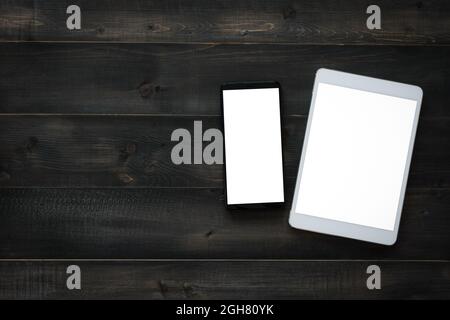 Mockup smartphone and tablet blank screen on a wooden table, top view, flat lay, and copy space Stock Photo