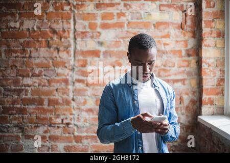 Businessman using mobile phone in office Stock Photo