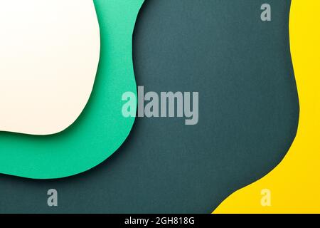 Paper background with various colored wavy layers. Empty room for text. Top view. Flat lay Stock Photo