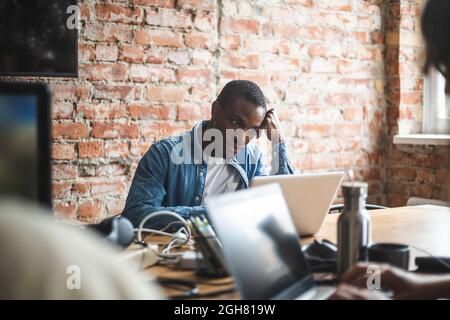 Businessman using laptop while working in office Stock Photo