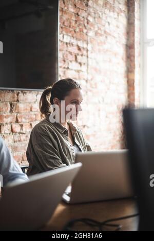 Female hacker working at creative office Stock Photo