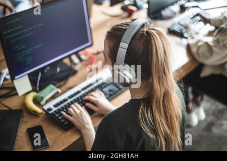 High angle view of female programmer working at startup company Stock Photo