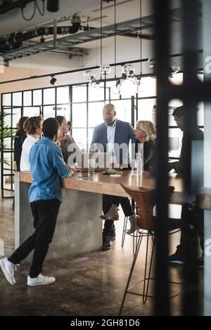 Business people sharing ideas in meeting at creative office Stock Photo