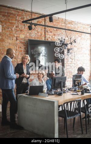 Business professionals discussing at startup company Stock Photo