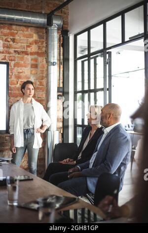 Confident businesswoman discussing with male and female investors at office Stock Photo
