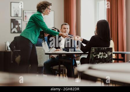 Female entrepreneurs holding digital tablet at corporate office Stock Photo
