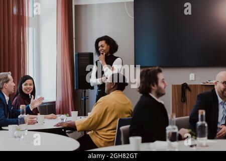 Business professionals discussing during meeting in corporate office Stock Photo