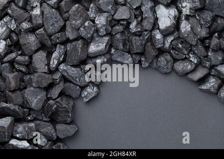 Natural black coals over black background with copy space. Top view Stock Photo