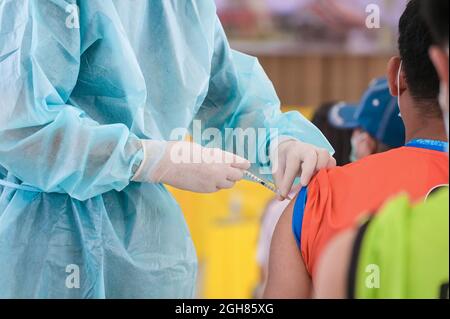 Doctor giving shot injection vaccine patient shoulder. Vaccination prevention virus covid19 pandemic Stock Photo