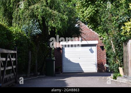 A rural English village driveway and garage on a sunny summers day Stock Photo