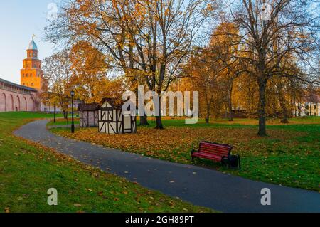 Veliky Novgorod, Russia - October 17, 2018. Kremlin park in autumn evening. Kokui ower of Veliky Novgorod Kremlin and beautiful autumn park alley Stock Photo