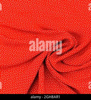 Silk fabric. white peas on red. Texture, background, pattern. Stock Photo