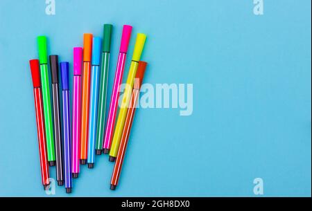 multicolored markers on a blue background. learning concept Stock Photo