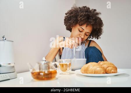 Female looking at her morning meal in disgust Stock Photo
